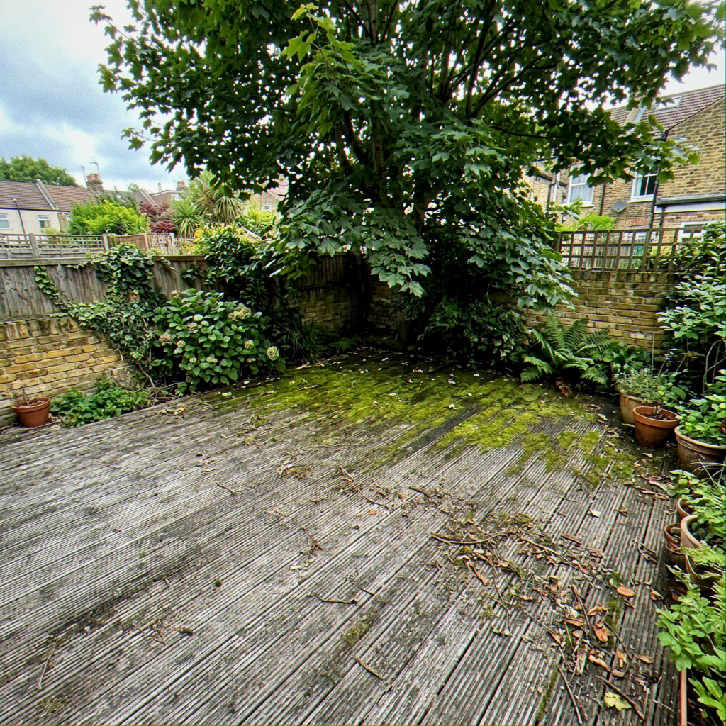 Before. The boards weathered grey and overdue a coat.